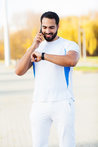 Fit muscular man running and doing exercise outside