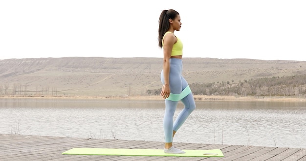 Fit woman doing exercise with resistance band.