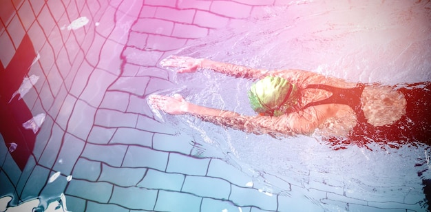 Fit woman swimming with swimming hat