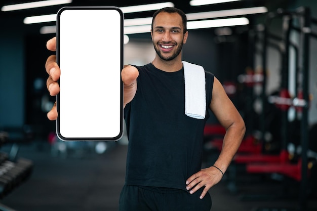 Fitness App Sporty Black Guy Showing Smartphone With Blank White Screen