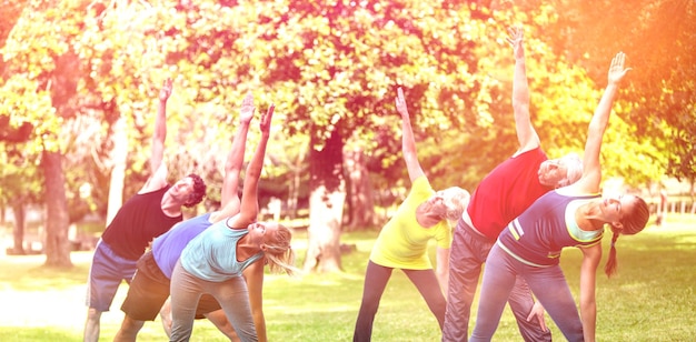 Fitness class stretching in the park