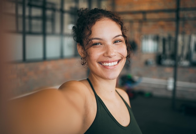 Fitness exercise and gym selfie portrait of a woman happy about workout training motivation and body wellness Young sports female or athlete with a smile for blog inspiration and progress post