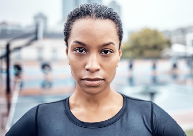 Fitness exercise and portrait of a woman athlete in the city for an outdoor run or sports training Serious motivation and face of young female runner with crossed arms after cardio workout outside