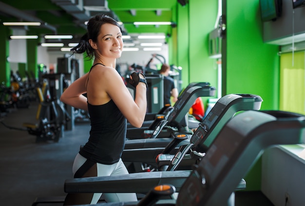 Fitness girl beautiful brunette running on treadmill morning. concept of a healthy lifestyle.