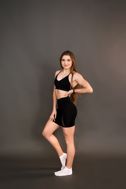 Fitness girl on dark background