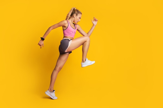 Fitness Girl Jumping Exercising On Pink Background Side View