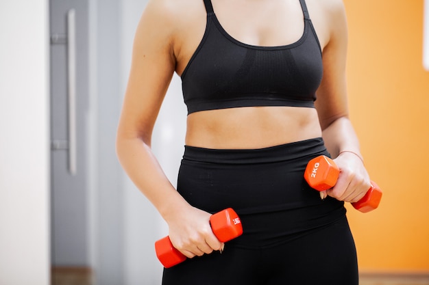 Fitness Girl. Sexy athletic girl working out in gym. Fitness woman doing exercise