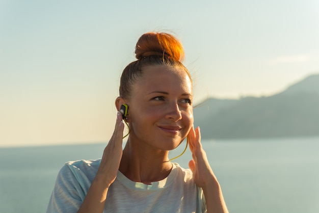 Fitness girl with wireless headphones