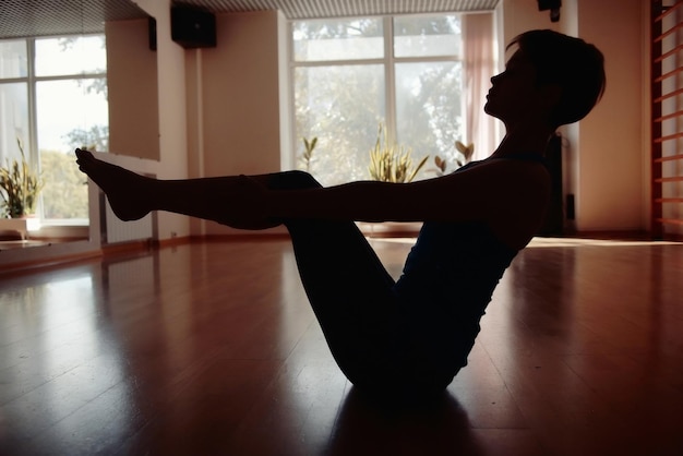 fitness girl yoga silhouette in the room