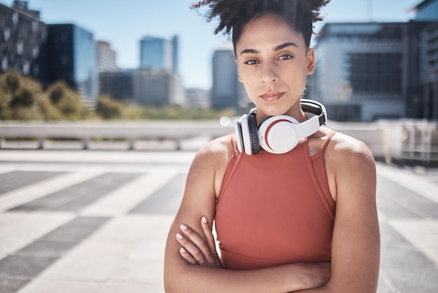 Fitness headphones and black woman in portrait for workout exercise or training motivation mental health and wellness in city Face of a sports athlete with music audio subscription or technology