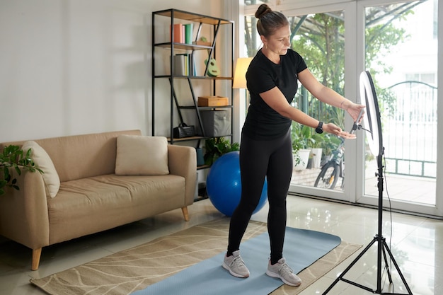 Fitness Instructor Setting Filming equipment