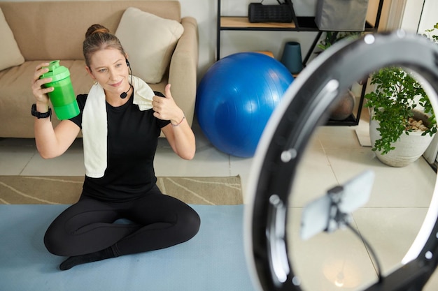 Fitness Instructor Showing Protein Shake