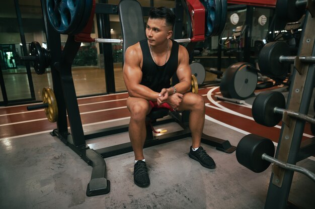 fitness man with training machine in gym