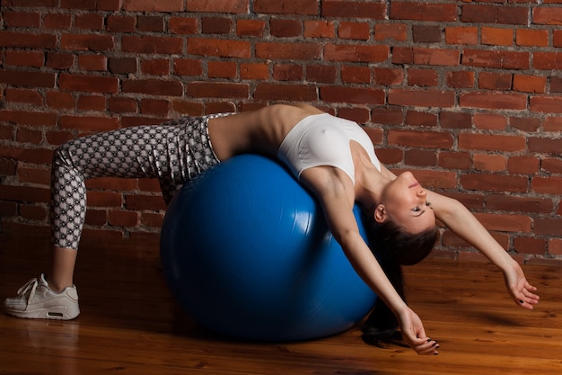 Fitness model exercising with fitball