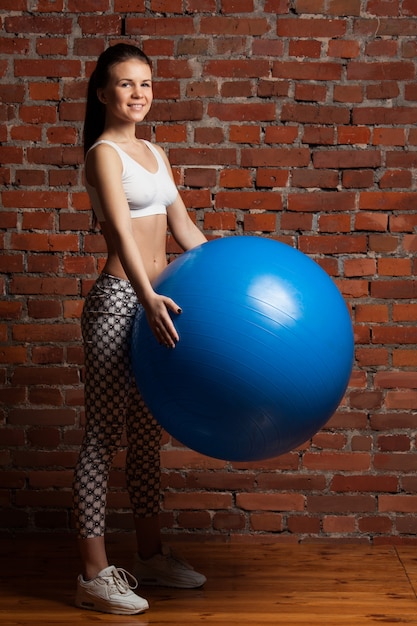 Fitness model exercising with fitball