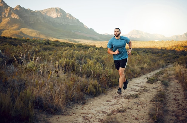 Fitness mountain and runner running on a trail in nature for exercise training and cardio workout outdoors Sports challenge and active athlete with endurance discipline and healthy body in Italy