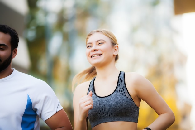 Fitness. Personal Trainer Takes Notes While Woman Exercising Outdoor