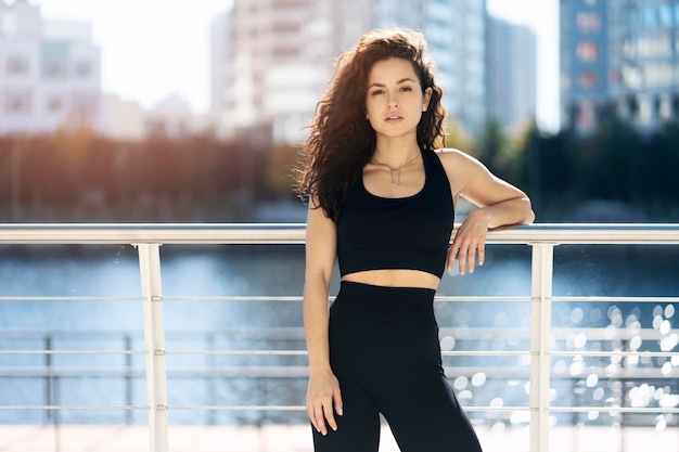 Fitness sport girl in fashion sportswear posing after fitness exercise in the street