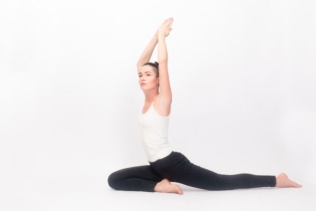 fitness sport training and lifestyle concept Young woman doing yoga exercise Portrait of young beautiful girl in white sportswear doing yoga practiceWoman doing stretching exercise