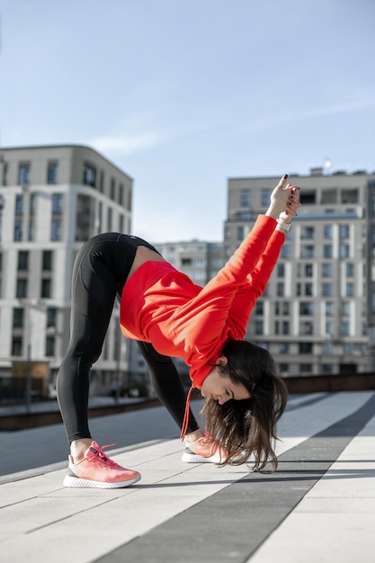 Fitness woman is fitness stretching and exercising outdoor in urban environment