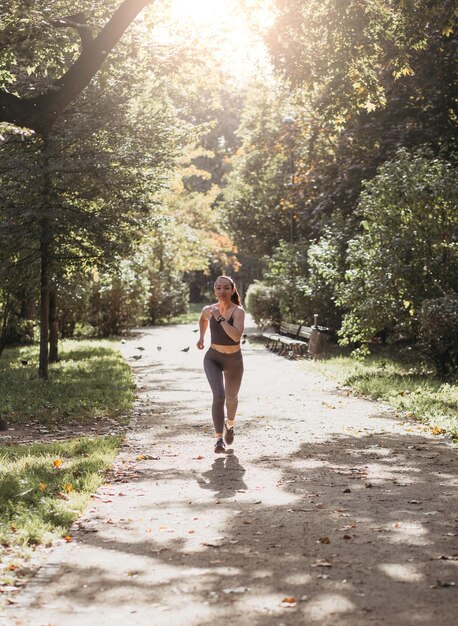 Fitness woman run in summer park Sport Healthy concept