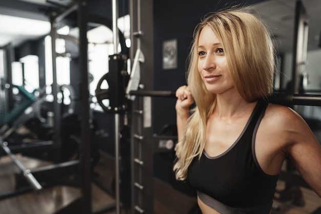 Fitness woman in sport outfit exercising in gym