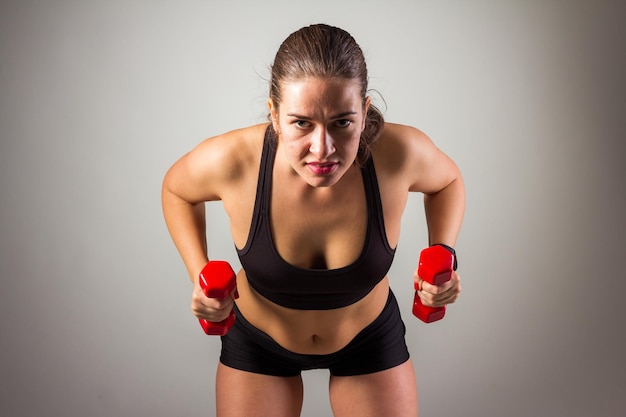 Fitness woman working out on the floor isolated on a white background