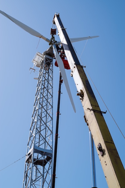 Fitters use truck crane and aerial platform to install wind turbine rotor