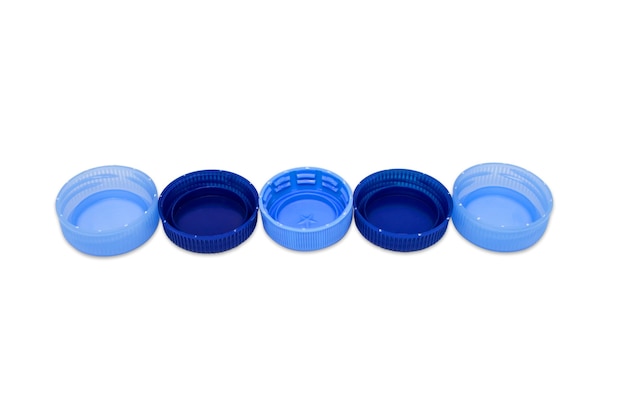 Five blue plastics caps in line isolated on white background. Recycling concept