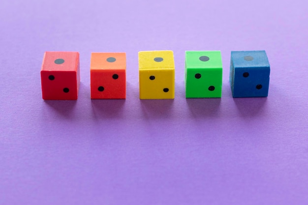 Five colored rubber dice showing the Colors representing the LGBT community