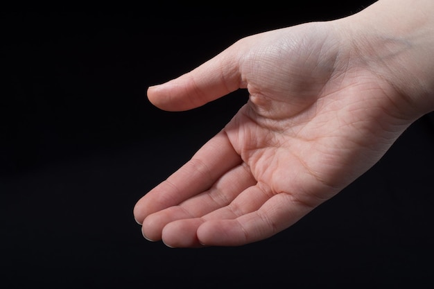 Five fingers of a human hand partly seen in view