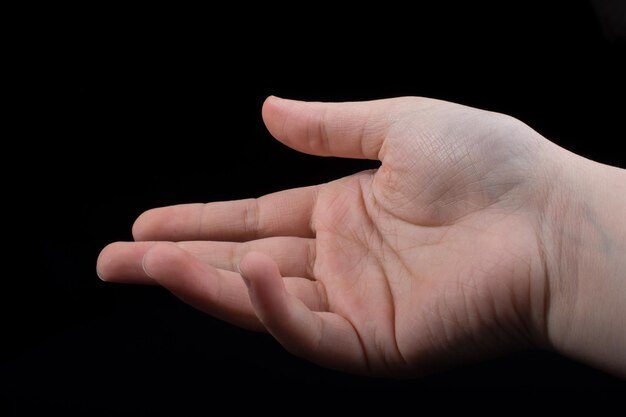 Five fingers of a human hand partly seen in view