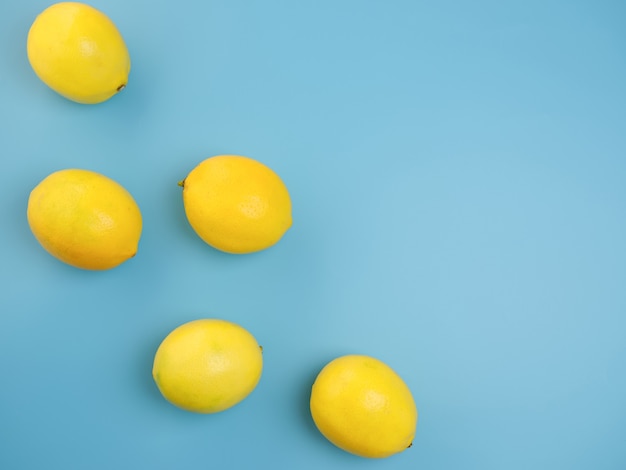 Five lemons on a blue wall