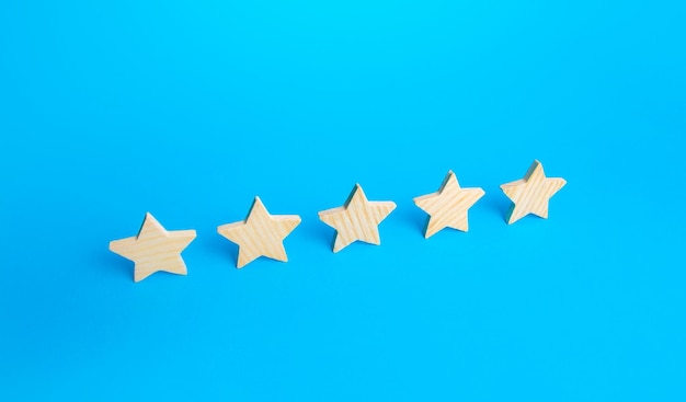 Five stars are in a row on a blue background Rating evaluation concept Popularity of restaurants hotels or mobile applications Service quality feedback Great reputation High satisfaction