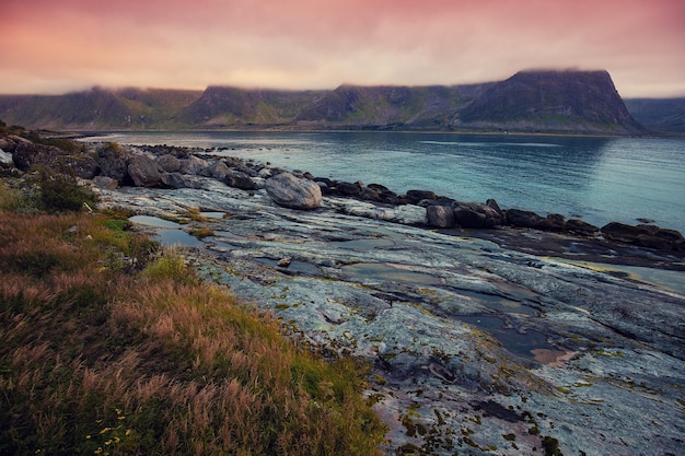 Fjord at sunset Rocky beach in evening Beautiful nature Norway Senja islands