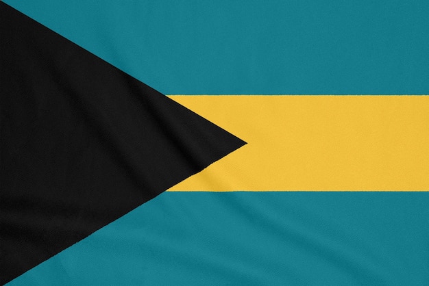 Flag of Bahamas on smooth silk texture. National symbol of Bahamas. Textile flag.