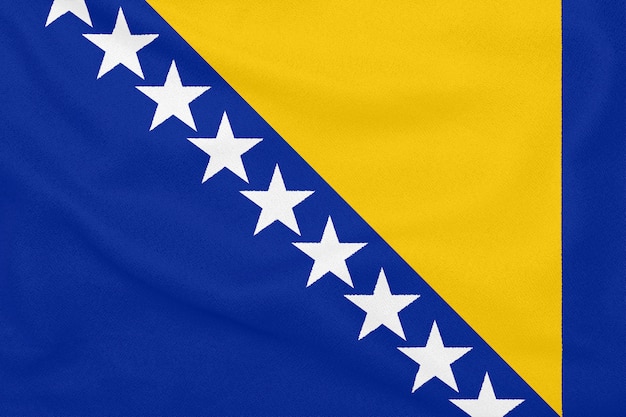 Flag of Bosnia and Herzegovina on textured fabric. Patriotic symbol