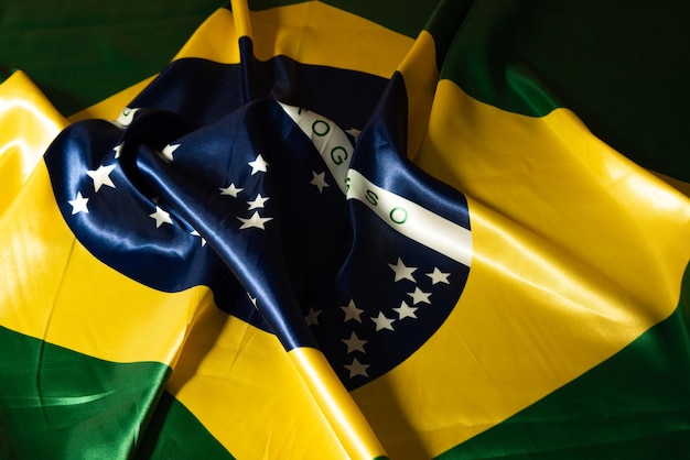 Flag of Brazil beautiful flag of Brazil arranged with folds on a table low key photo selective focus