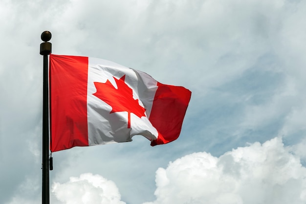 Flag of Canada on flagpole floating in the sky