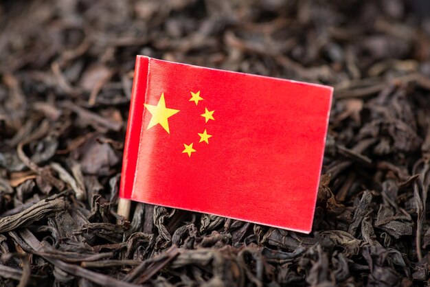 Flag of China on dried black tea Concept of tea business in China