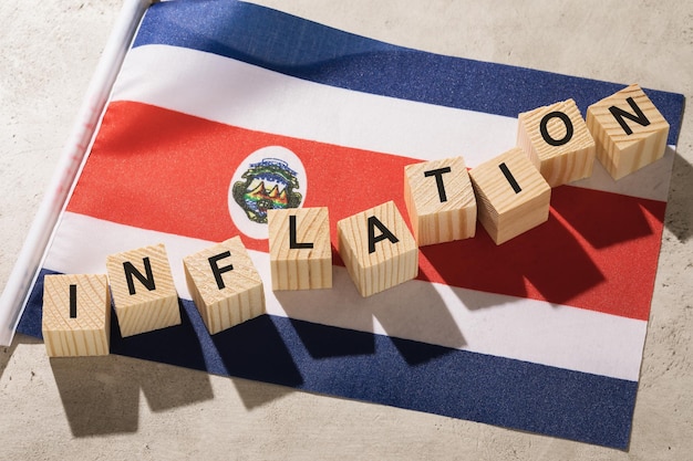 Flag of Costa Rica and wooden cubes with text a concept on the theme of inflation in the country