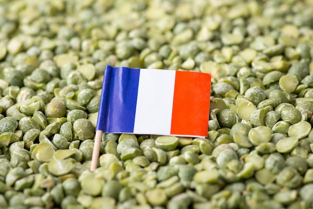 Flag of France on green pea close up Origin of pea growing pea in France concept