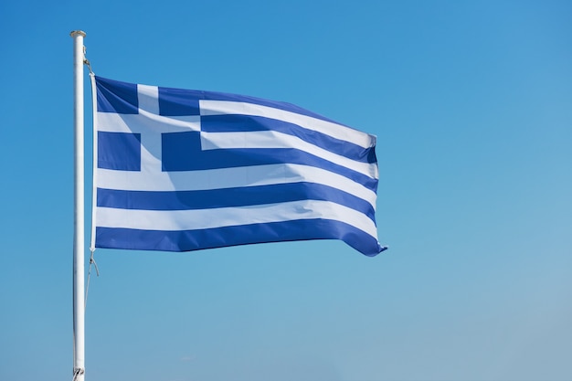 Flag of Greece - Waving greek flag agaist the blue sky with space for your own text