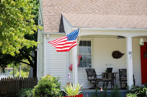 A flag on a house in the front yard