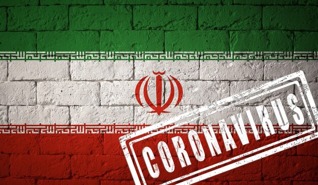 Flag of the Iran with original proportions. stamped of Coronavirus. brick wall texture. Corona virus concept. On the verge of a COVID-19 or 2019-nCoV Pandemic.