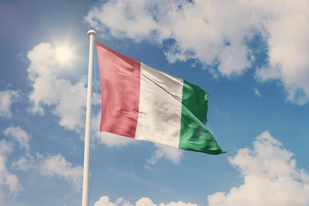 Flag of Italy, National symbol waving against cloudy, blue sky, sunny day