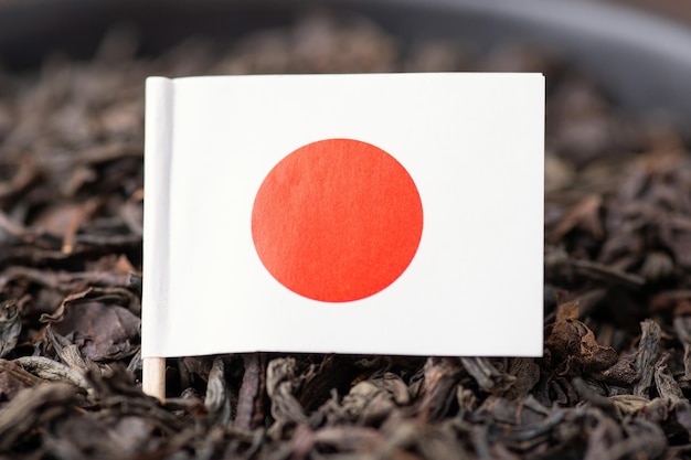 Flag of Japan on black tea leaves Growing tea in Japan concept