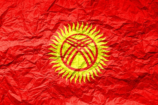 Flag of Kyrgyzstan on crumpled paper Textured background