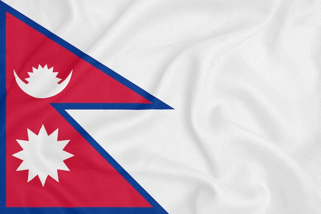 Flag of Nepal on textured fabric. Patriotic symbol