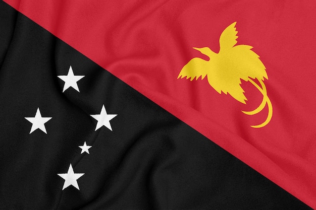 Flag of Papua New Guinea on textured fabric. Patriotic symbol